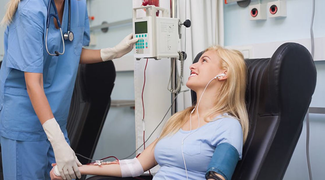 Frau sitzt in einem Untersuchungsstuhl