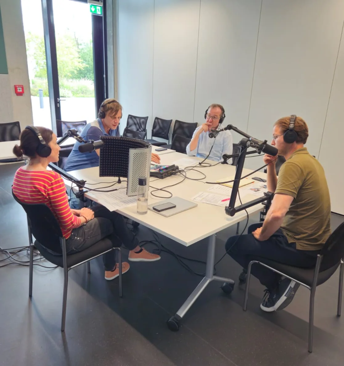 Standbild Podcast: Personen aus dem Interview sitzen an einem Tisch