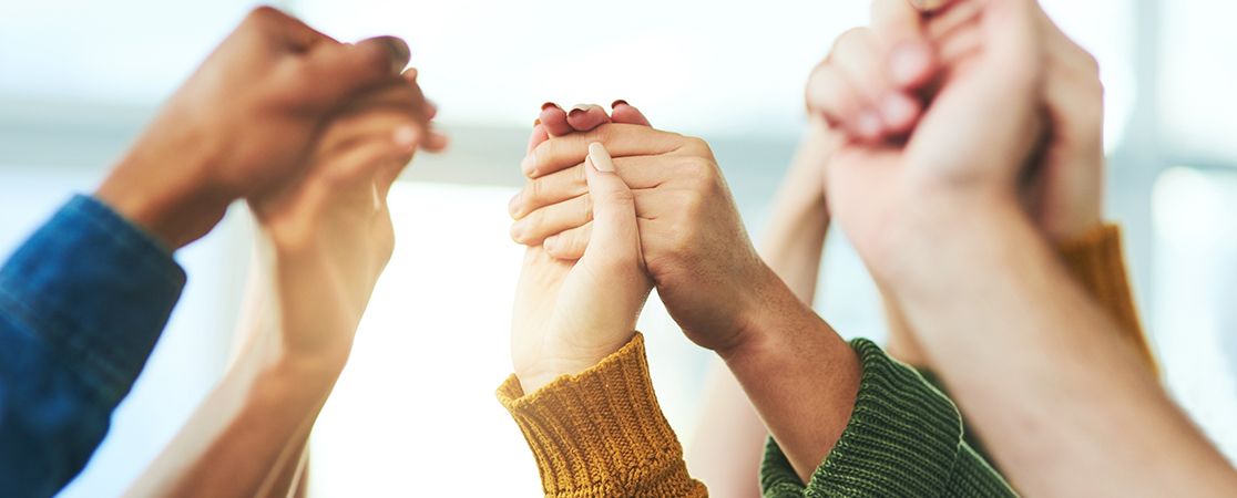 Symbolbild: Menschen halten sich an den Händen und recken sie empor