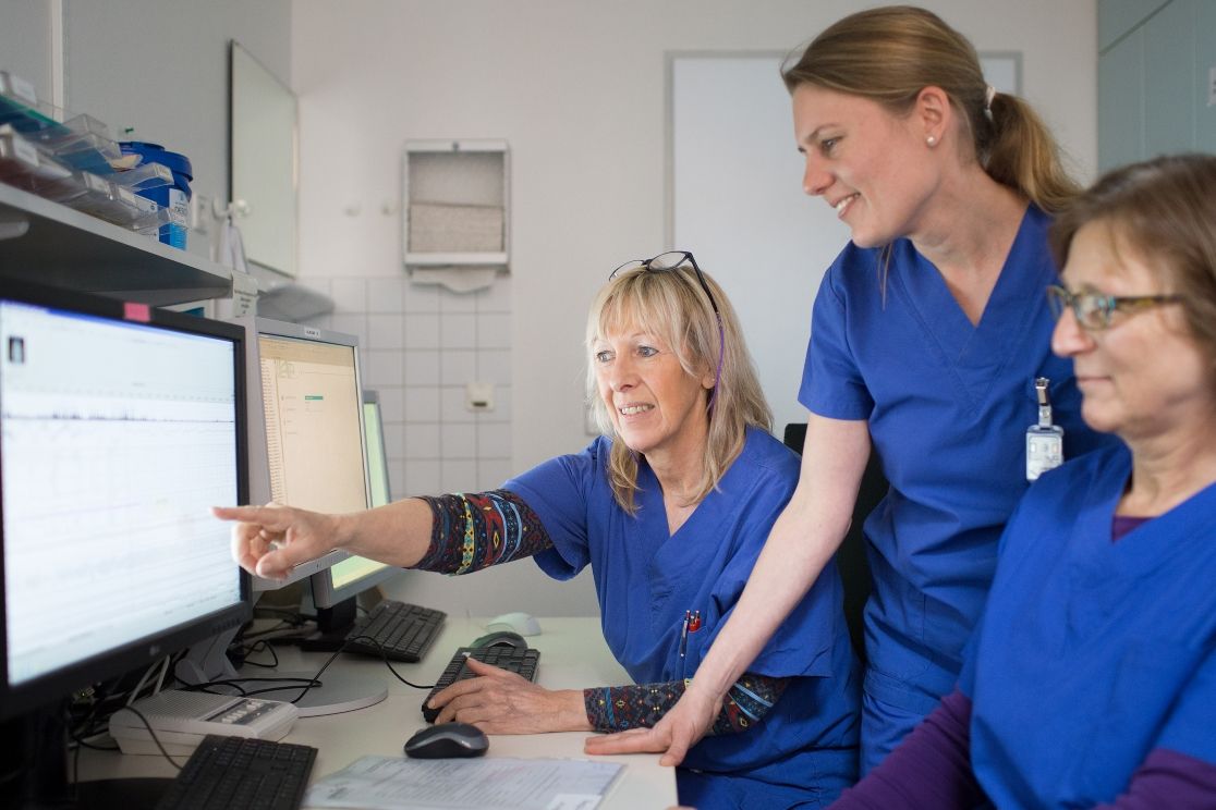 Three women look at one screen