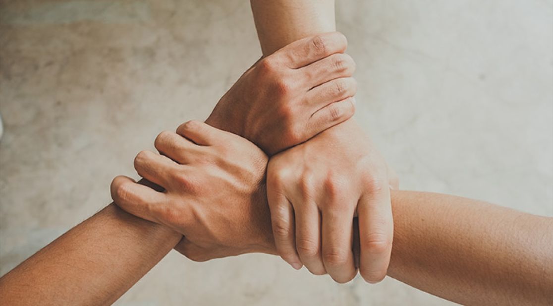 Three hands hold on to each other