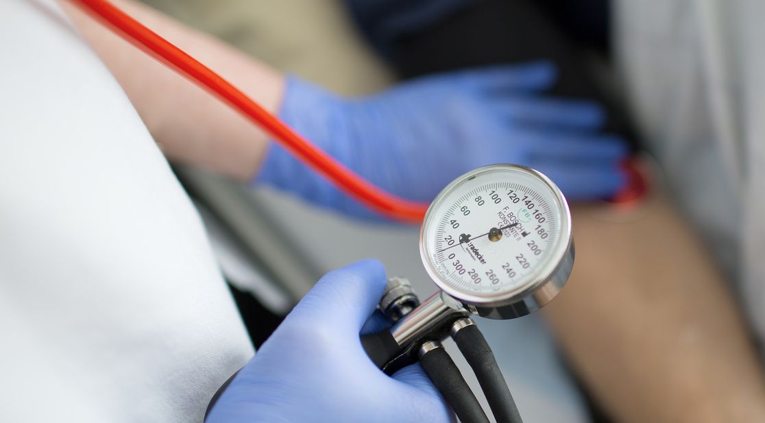 Symbolbild: Ärztin miss Blutdruck an Patient