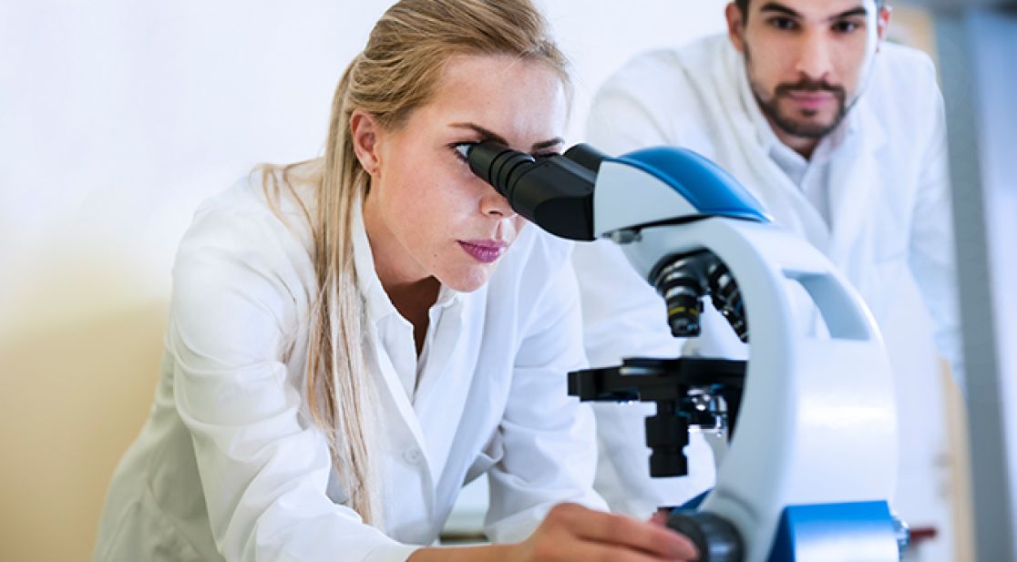 Woman looking through microscope